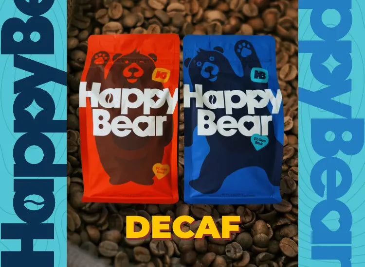 Orange and Blue Coffee Bags over coffee beans with the word Decaf