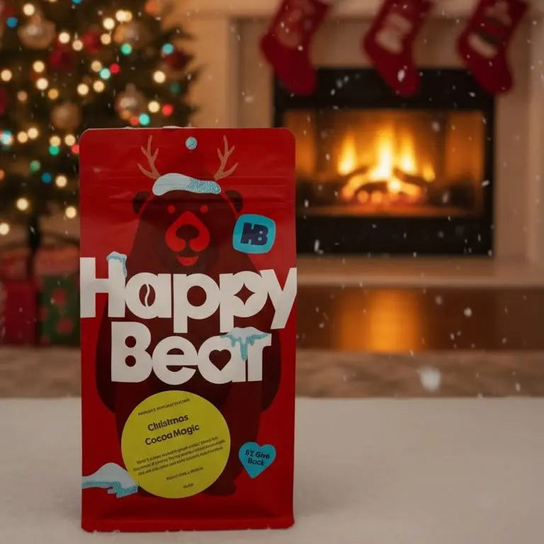 Red 'Happy Bear' package in front of a festive fireplace and Christmas tree.